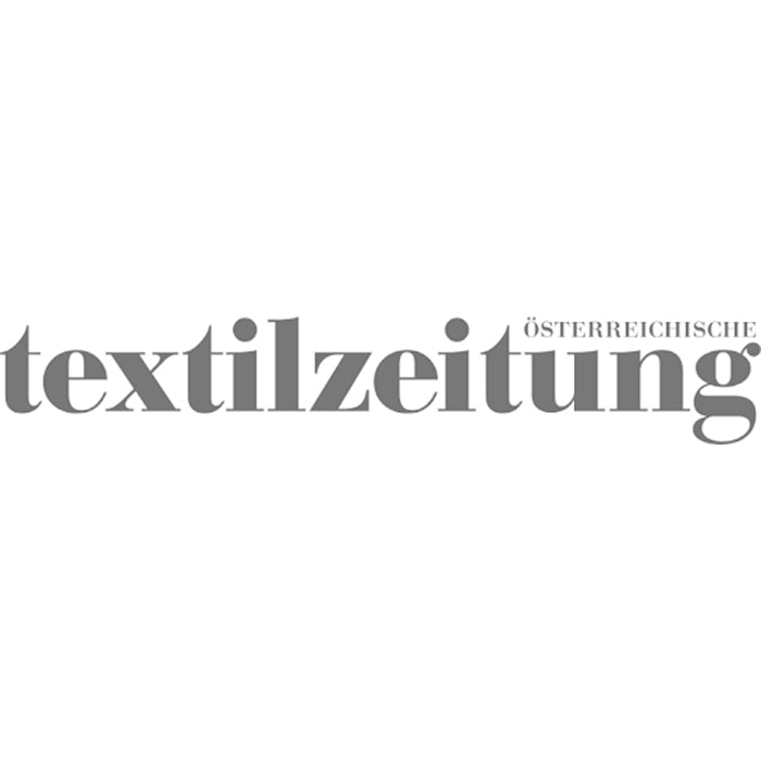 Logo österreichische Textilzeitung in grau
